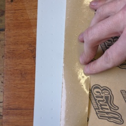 Peeling off the front part of the grip tape.