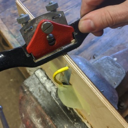 Using a spokeshave to make the cutout. It's a good idea to tape the connector out of the way so that you don't damage it.