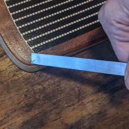 Using a chisel to cut the edge of the sensor flat with the footpad. A sharp knife should do the job as well.